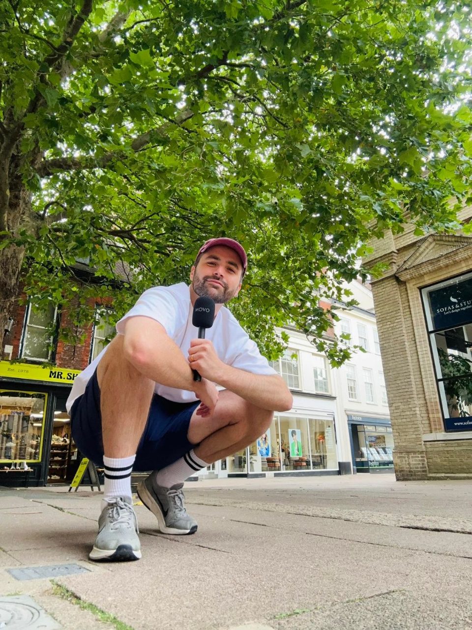 Jacob from Bury Juice, microphone in hand, on the high street
